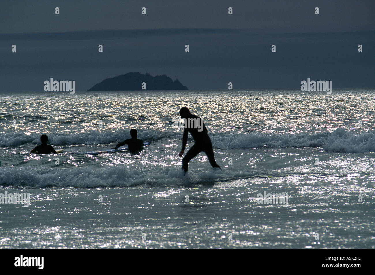 Playing in the surf Polzeath near Padstow Cornwall Great Britain Stock