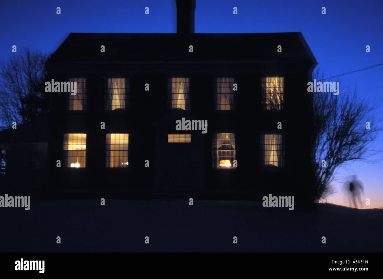 Ghostly image running around a house at night Stock Photo
