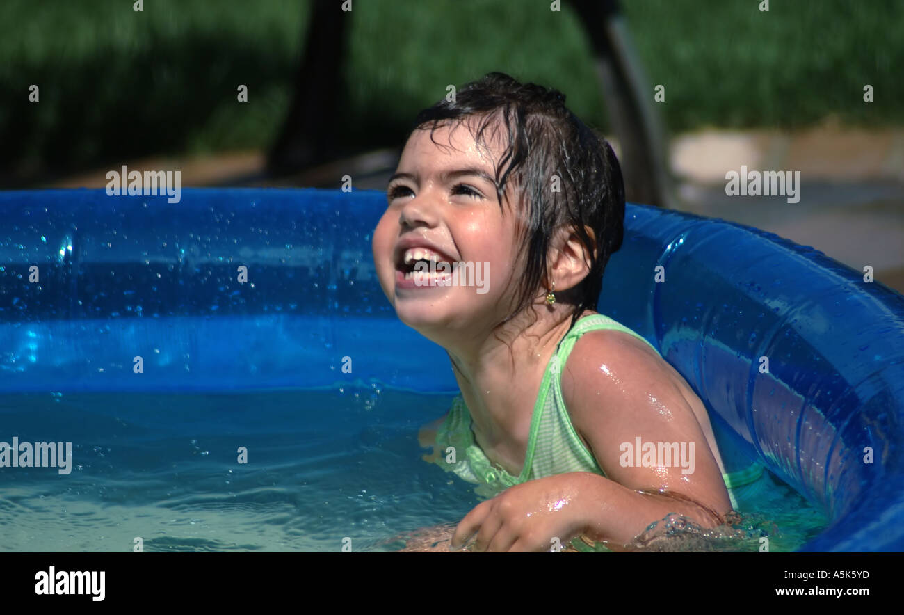 girl-laughing-having-fun-in-summer-swimming-pool-A5K5YD.jpg