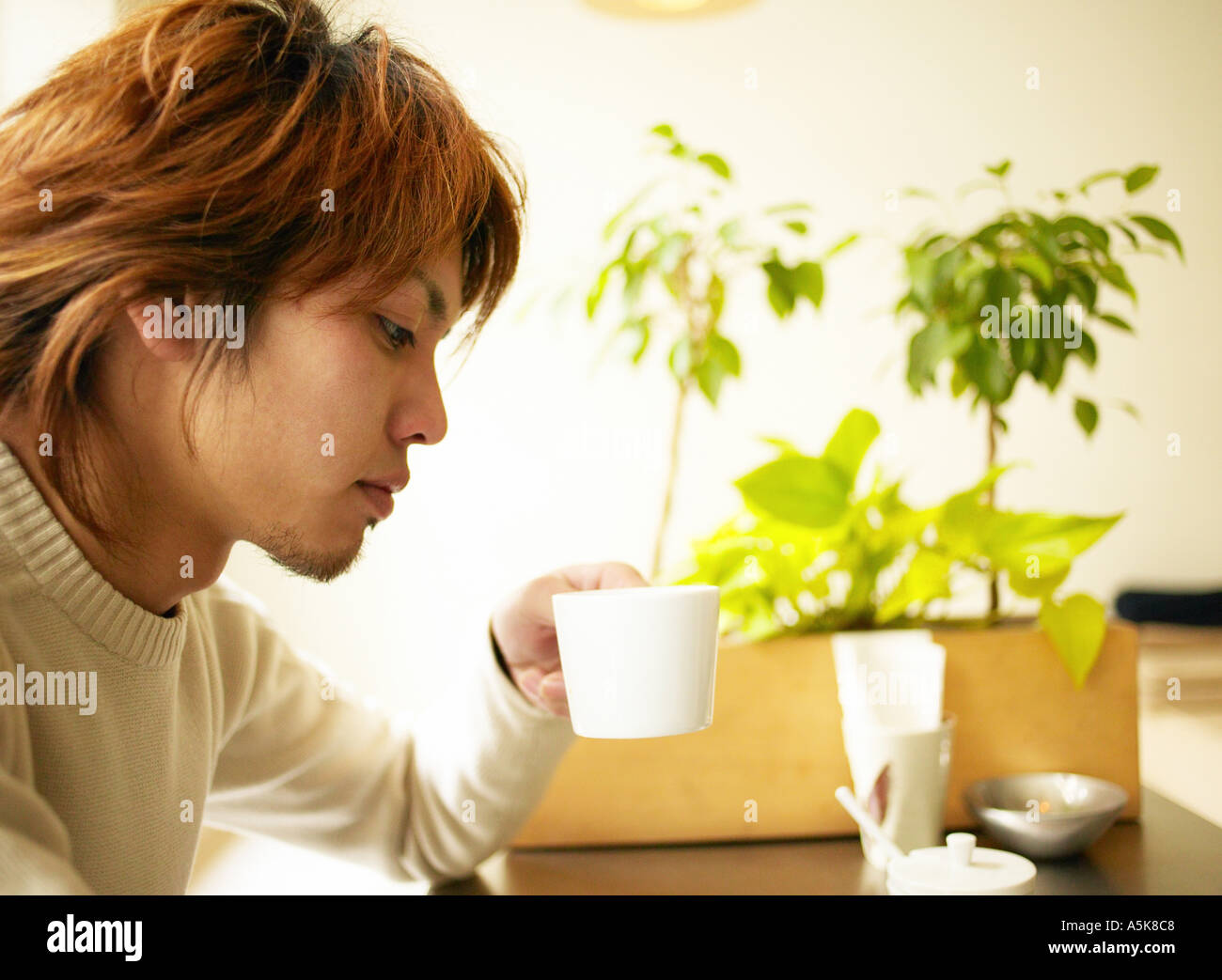 Young man drinking coffee Stock Photo