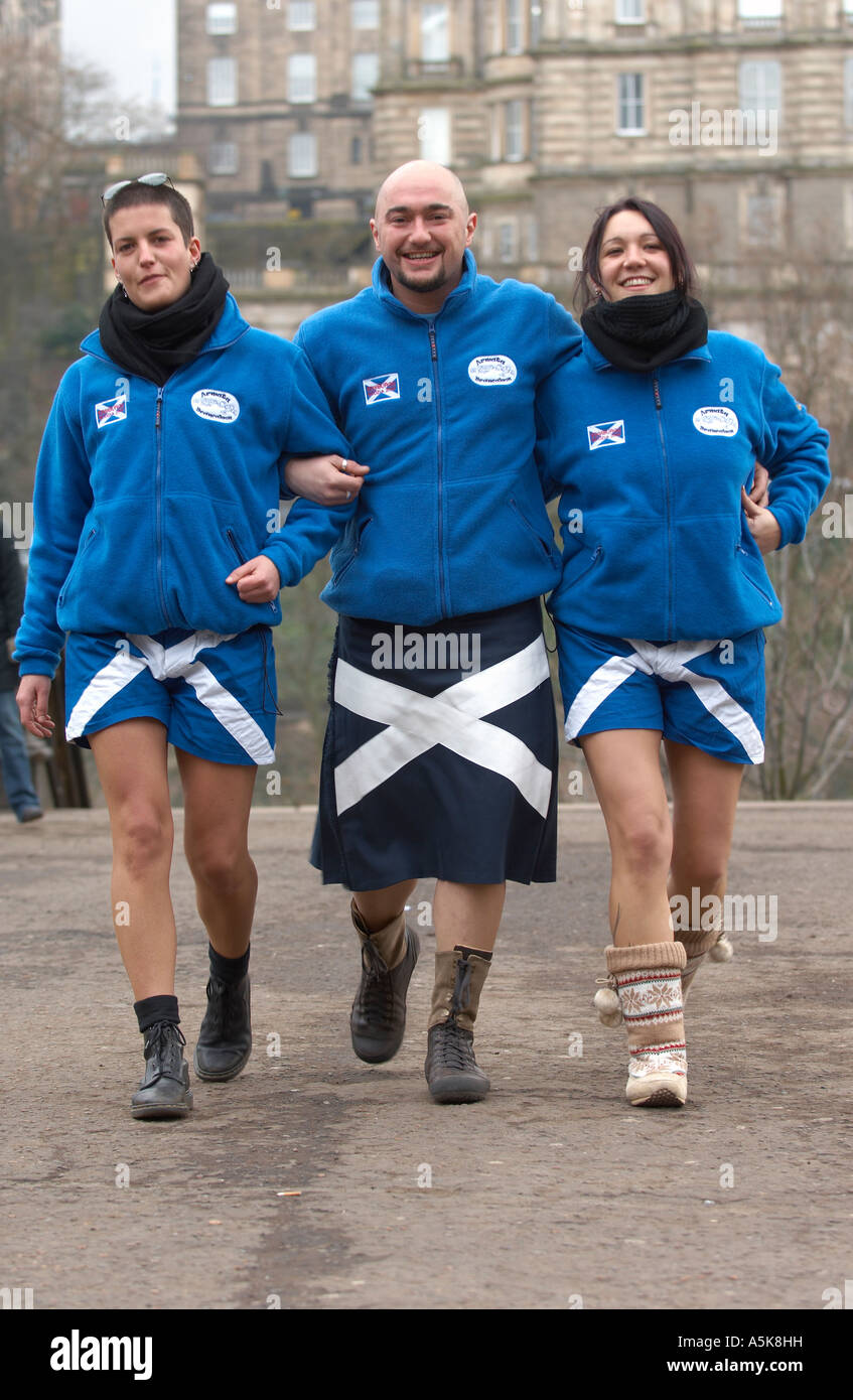 Italy rugby fans trio wearing kilt and shorts with large St Andrew crosses Stock Photo