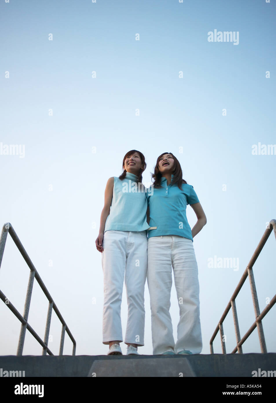 Two young women standing facing each other Stock Photo