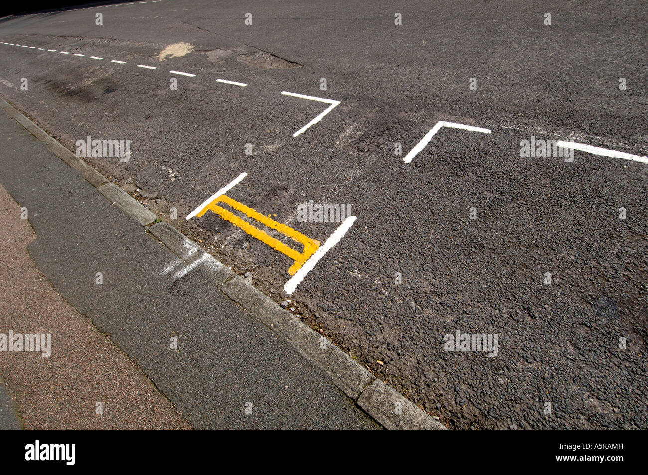 Very short and very silly looking double yellow line parking restrictions just 39 inches long on a road in Falmer East Sussex Stock Photo