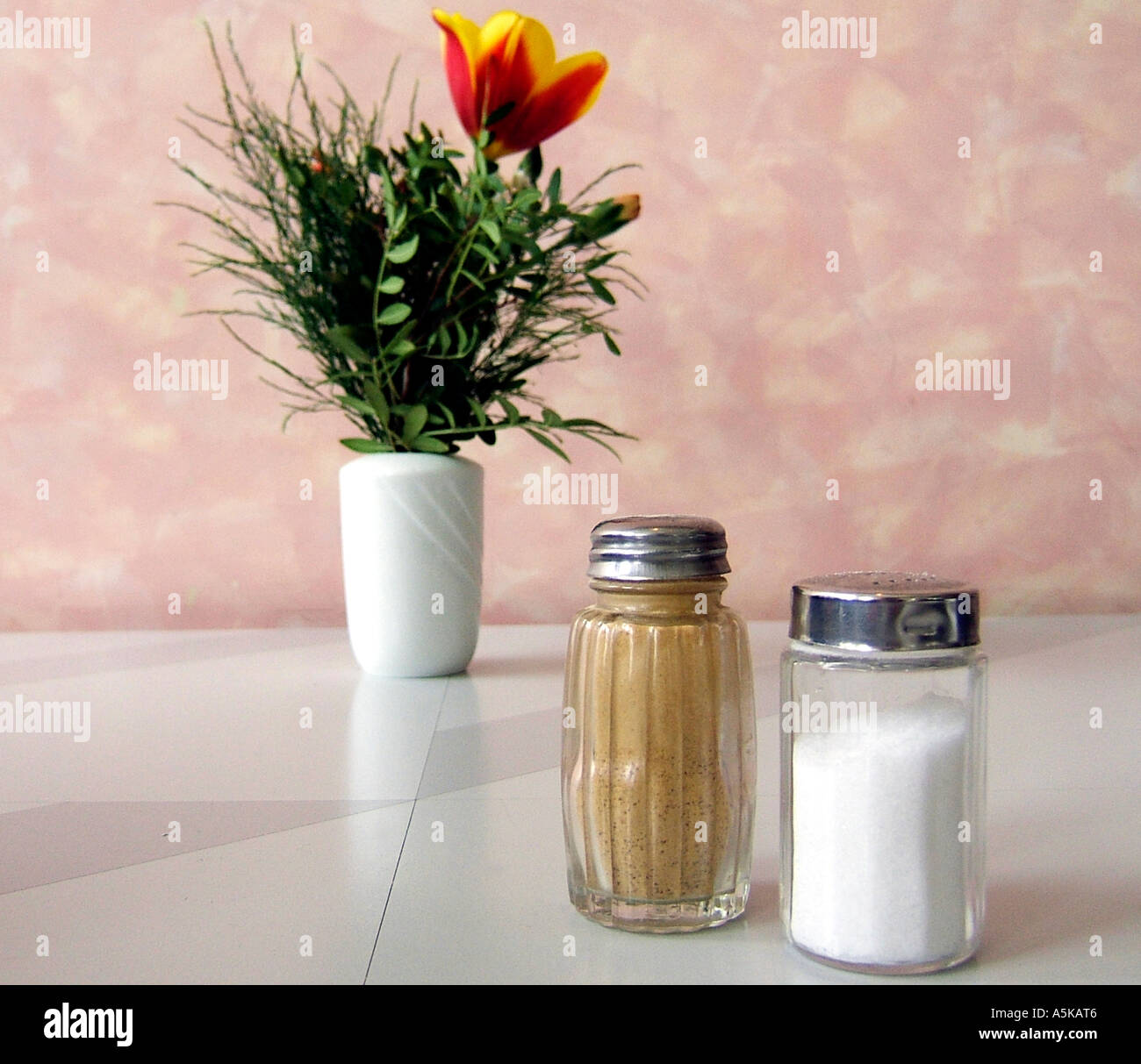 Salt, pepper and flowers on a restaurant table Stock Photo Alamy