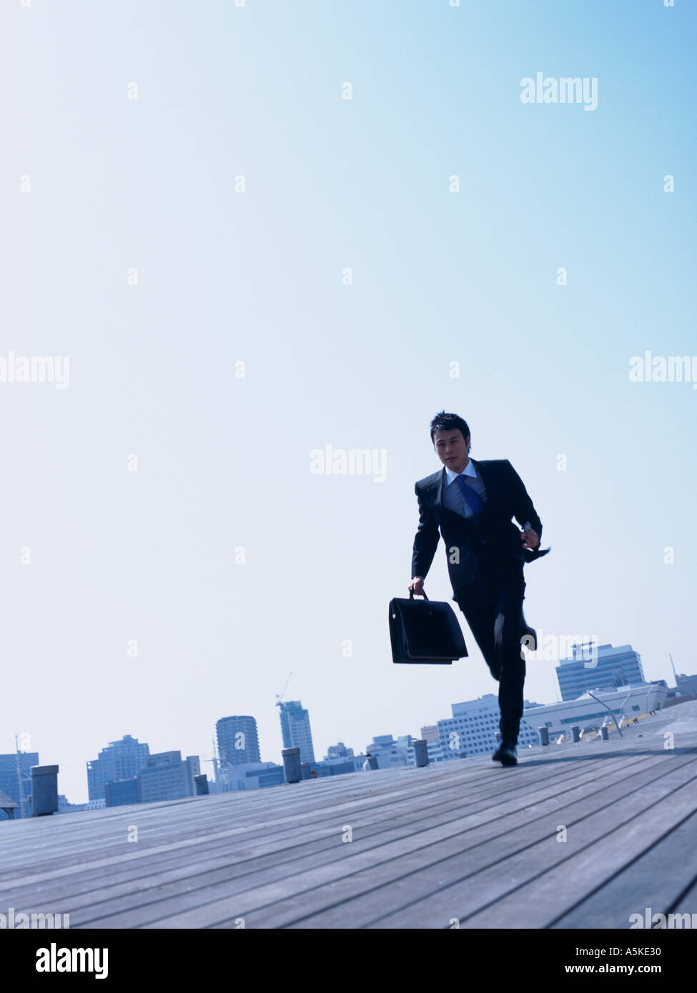 Asian Man running on a walkway Stock Photo - Alamy