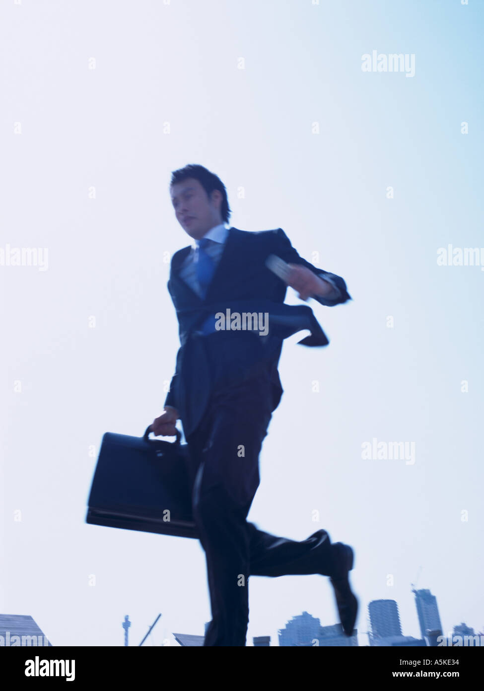 Asian Man running on a walkway Stock Photo - Alamy