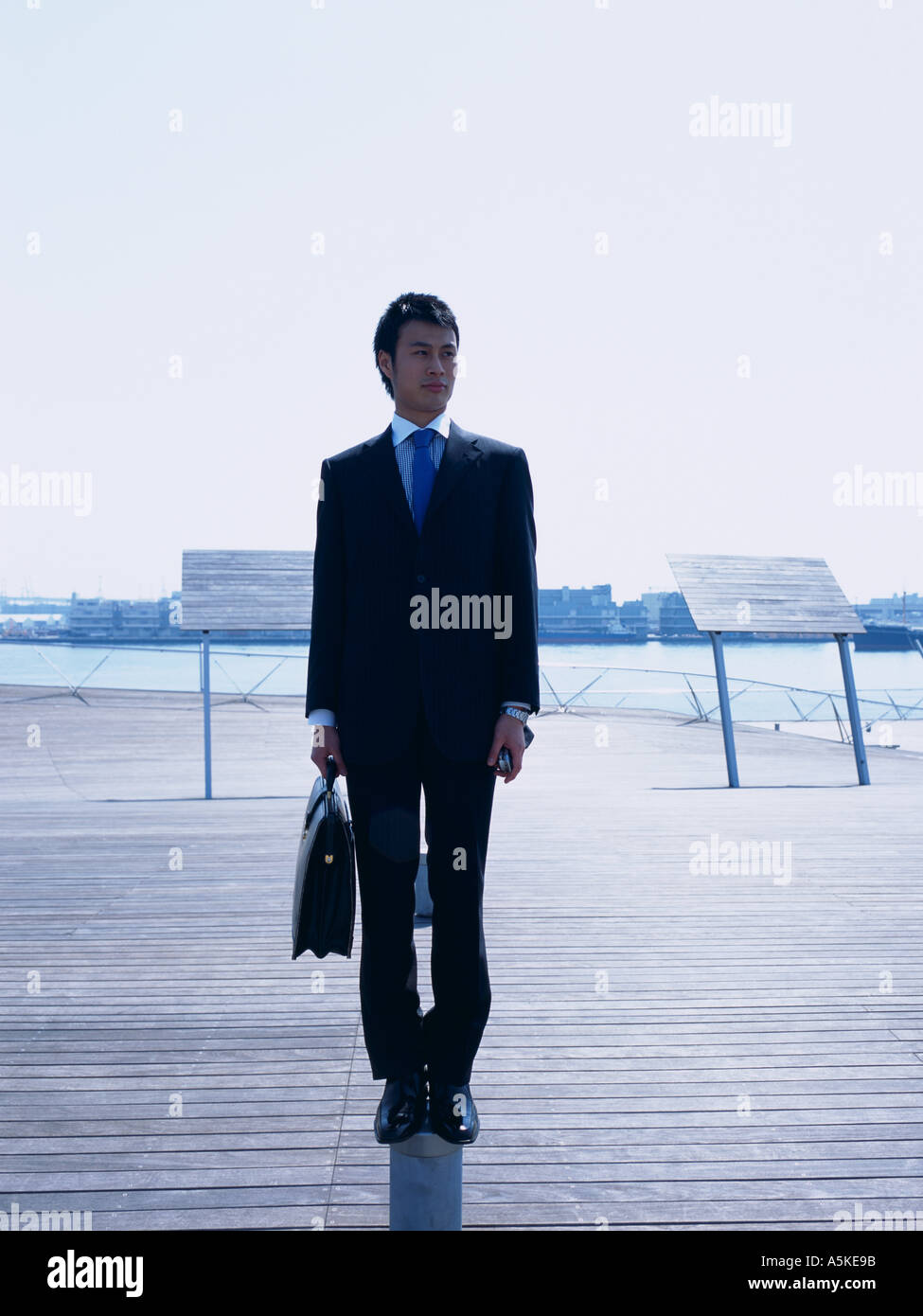 Asian man standing on a walkway Stock Photo