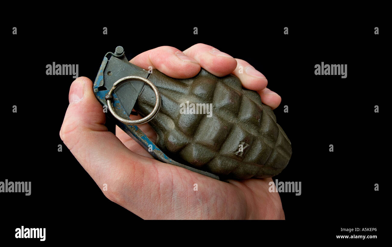Hand grasping a hand grenade Familiar pineapple form M21 grenade Stock Photo