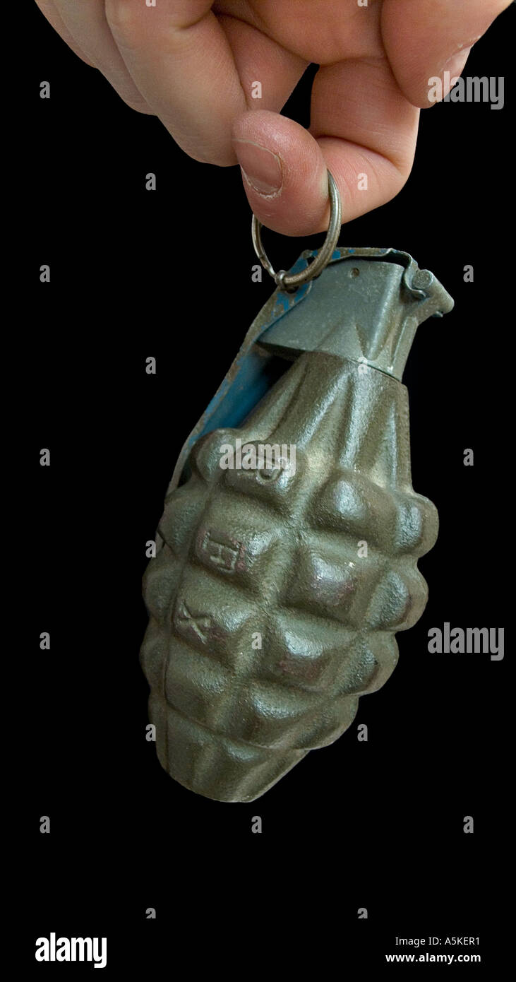 Hand grasping a hand grenade Familiar pineapple form M21 grenade USA