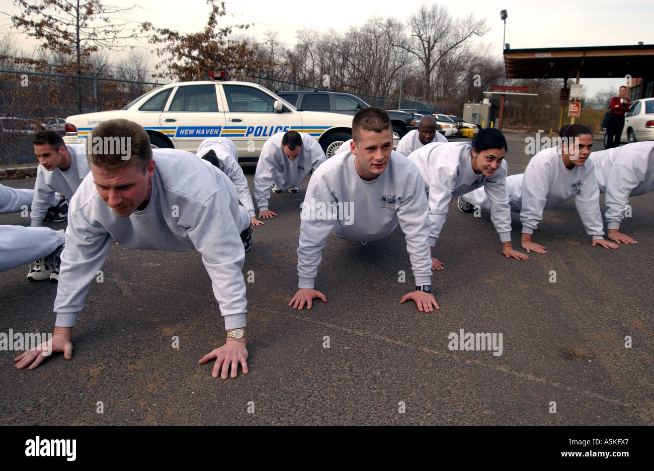 Police at the New Haven Police Academy do push ups during physical training Stock Photo