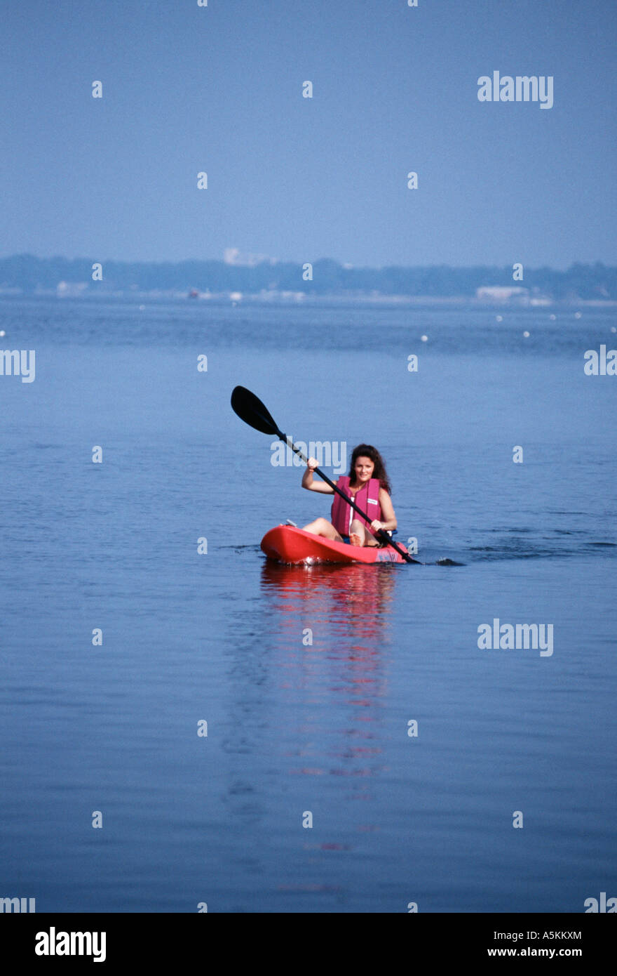 VA Chesapeake Bay Woman kayaking in raspberry Ocean Kayak Stock