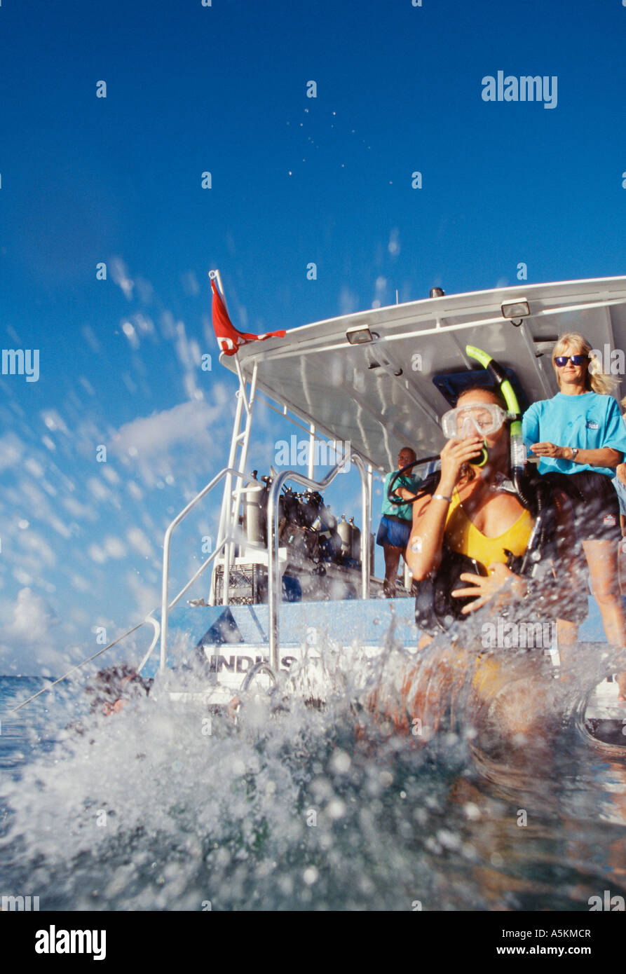 Grand Cayman Diver takes giant stride off edge of dive boat Stock Photo