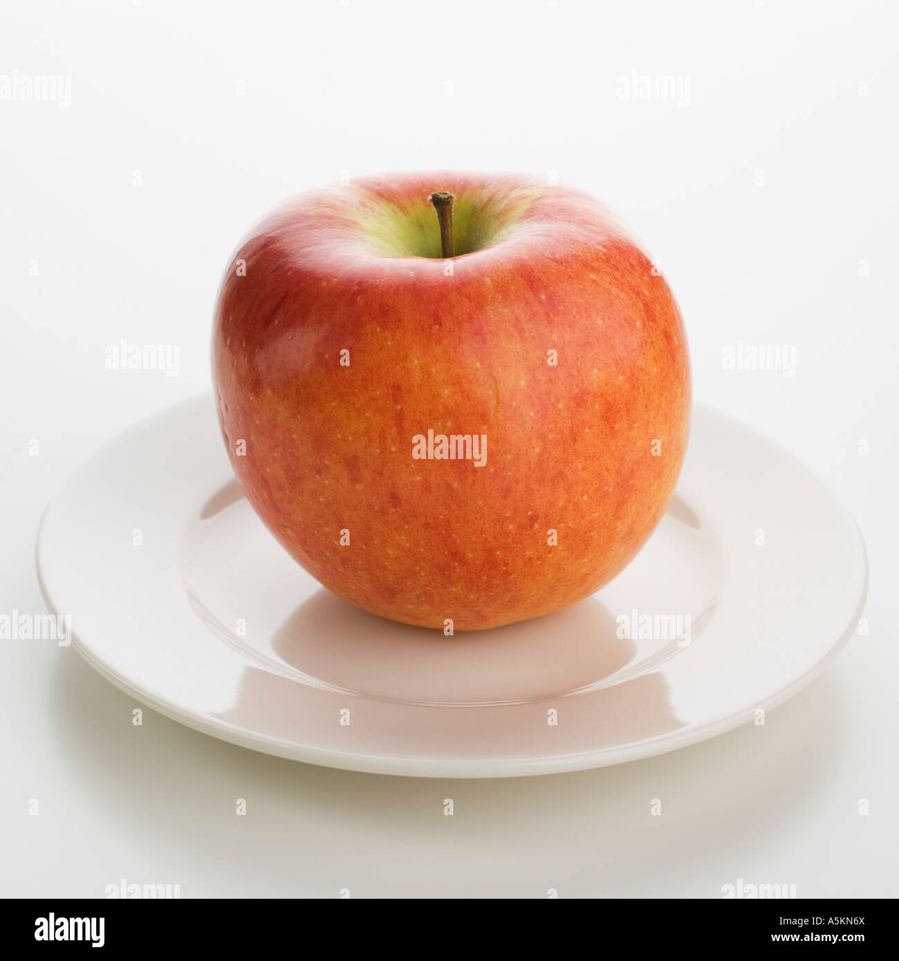 There is a apple on the. Take an apple from the plate picture.