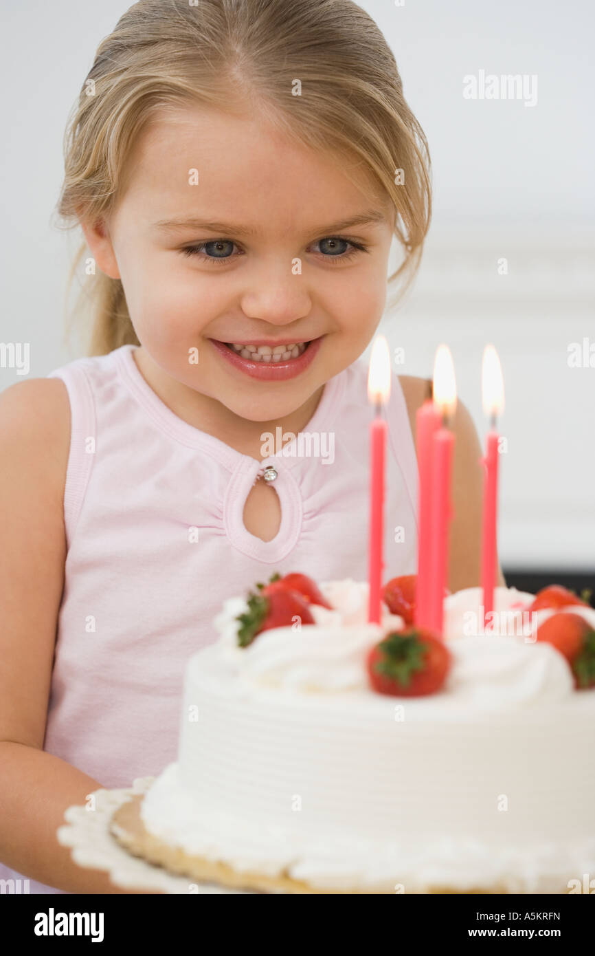 Girl smiling at birthday cake Stock Photo - Alamy