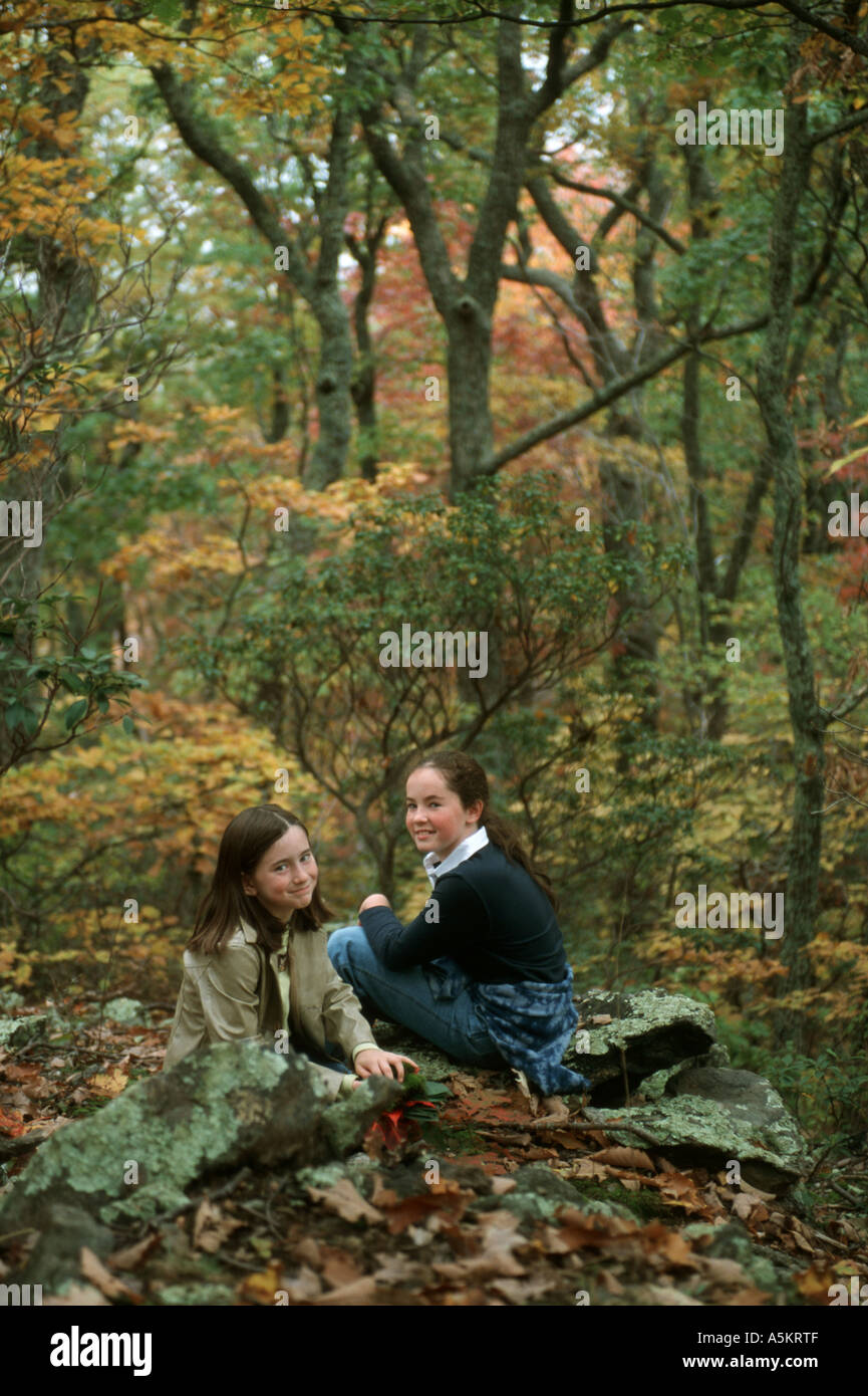 Two girls take a rest from a hike off the Blue Ridge parkway in the ...