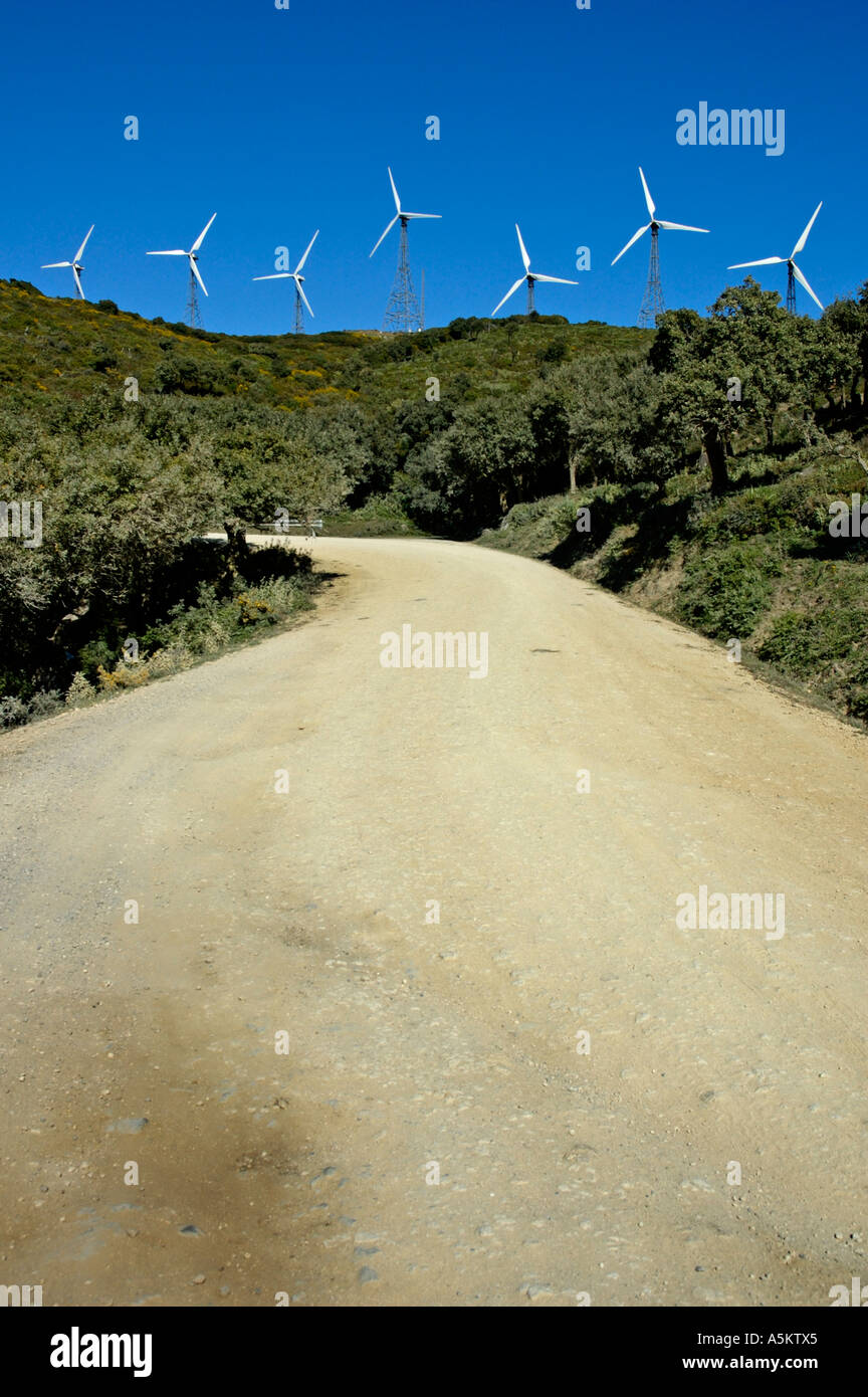 Wind turbines on hill above dirt road, Tarifa, Andalucia, Spain. Stock Photo