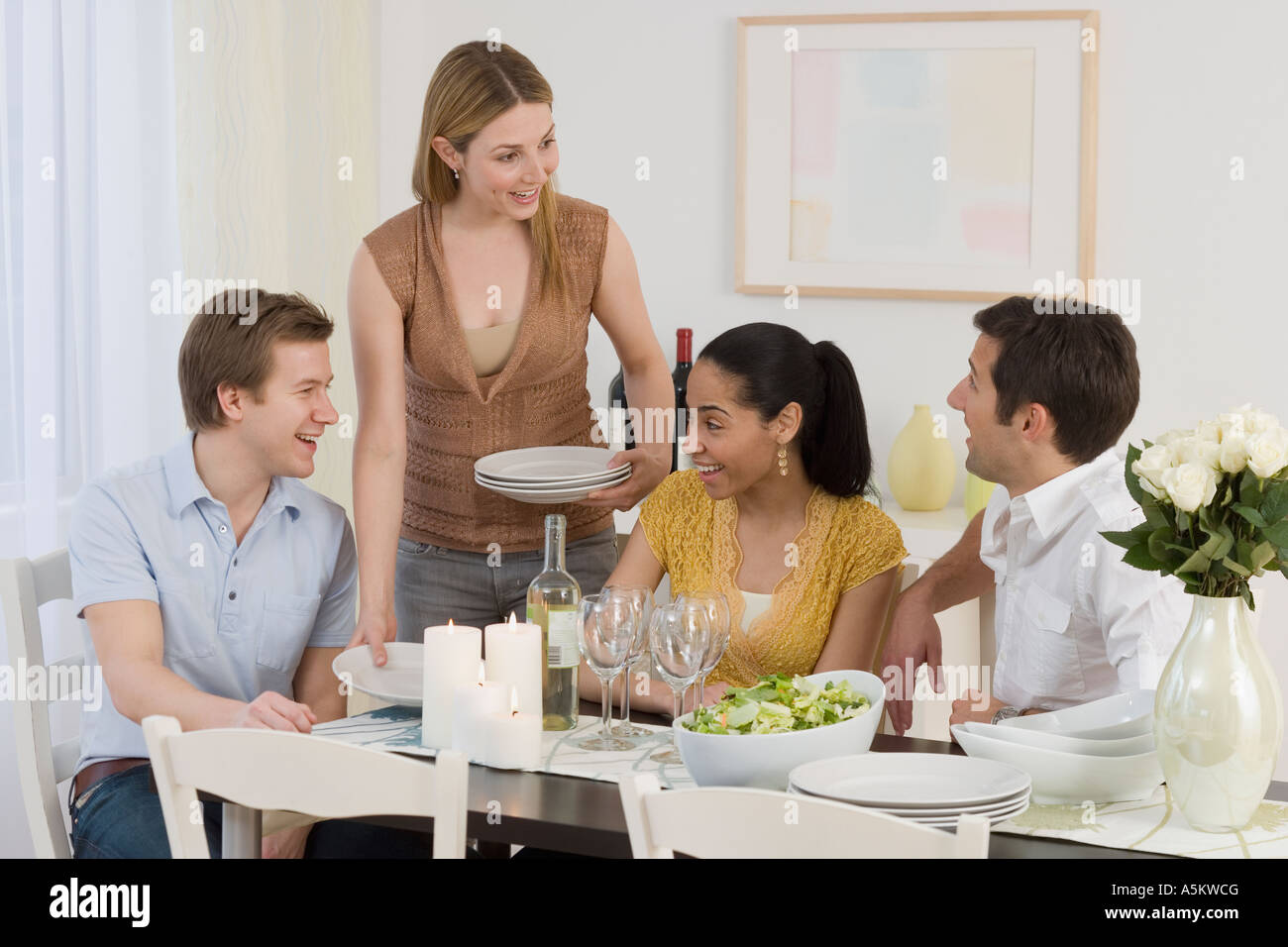 Two couples having dinner party Stock Photo