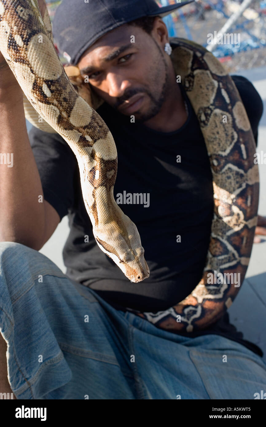 Man with pet python on the boardwalk at Coney Island Stock Photo - Alamy