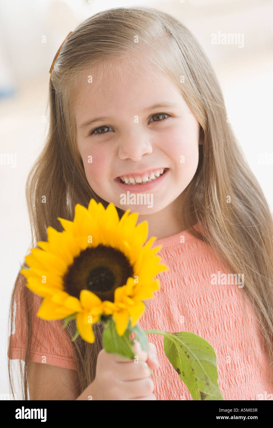 Portrait of girl holding sunflower Stock Photo Alamy