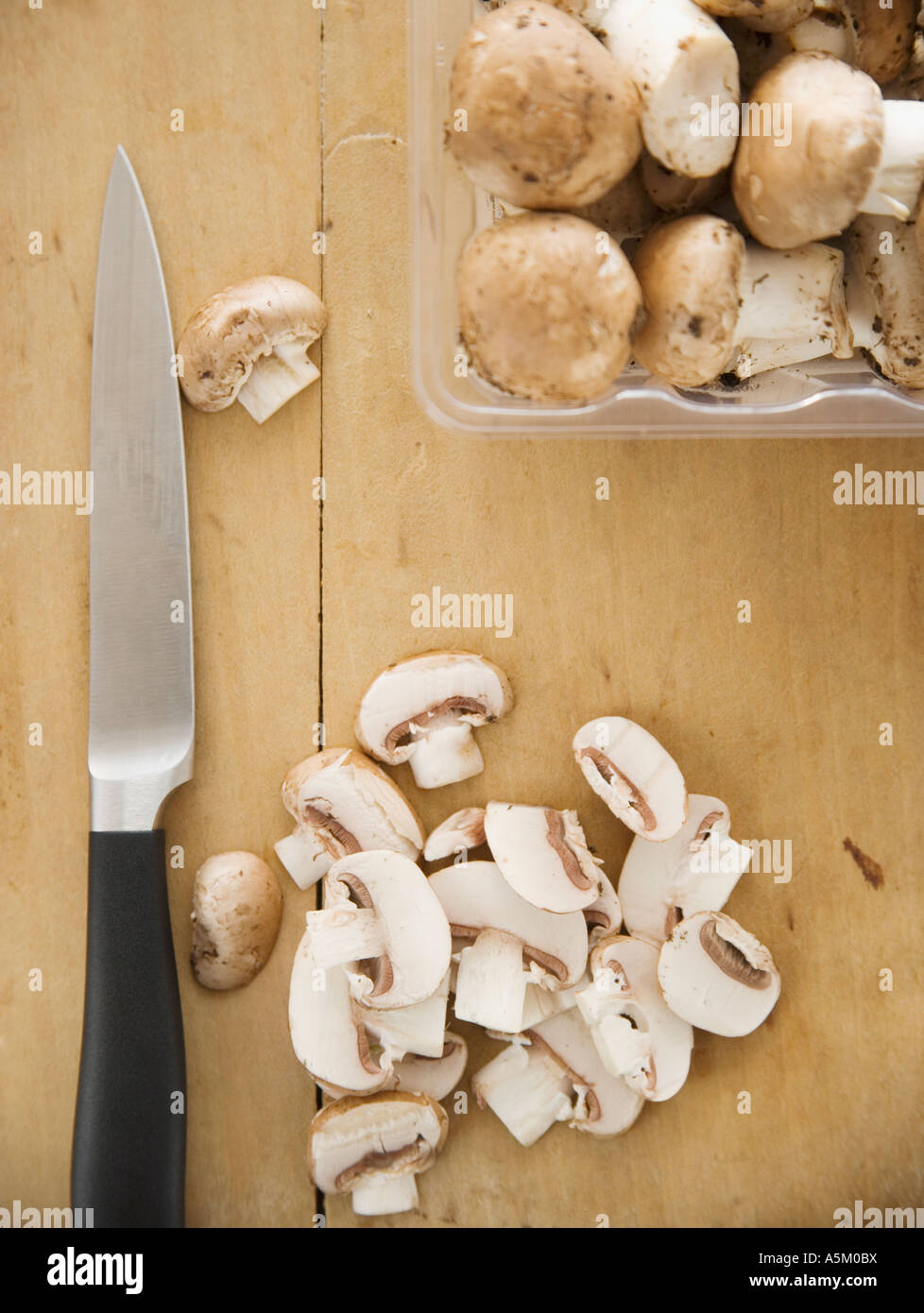 Chopped mushrooms on cutting board Stock Photo
