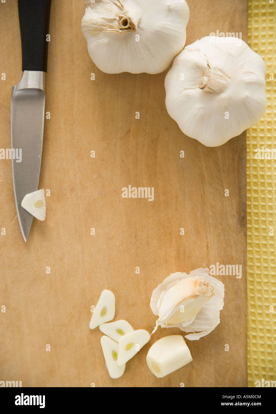 Chopped garlic on cutting board Stock Photo