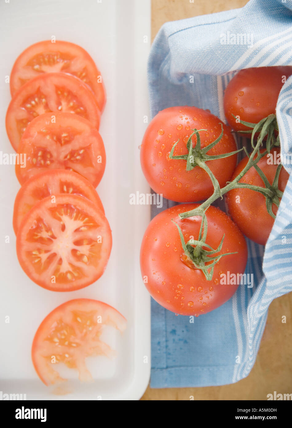 Sliced tomatoes on cutting board Stock Photo