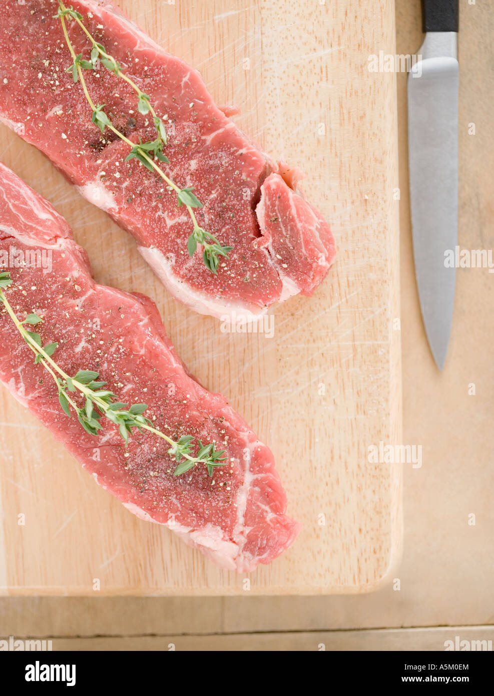 High angle view of meat and spices on cutting board Stock Photo