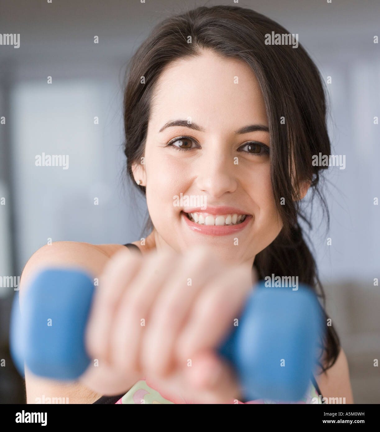 Portrait of woman lifting weights Stock Photo