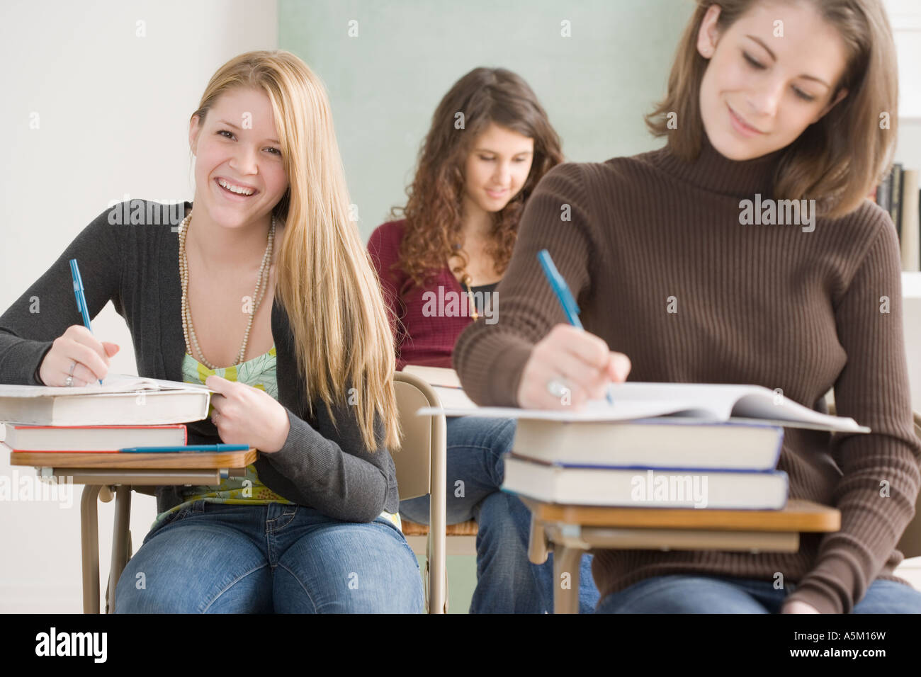 Female students working in classroom stock photo alamy