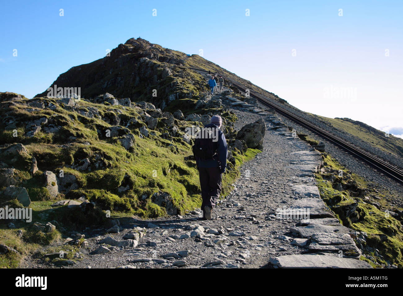 Walker on the final approach to the Summit of Mt Snowdon Snowdonia National Park Gwynedd Wales Stock Photo
