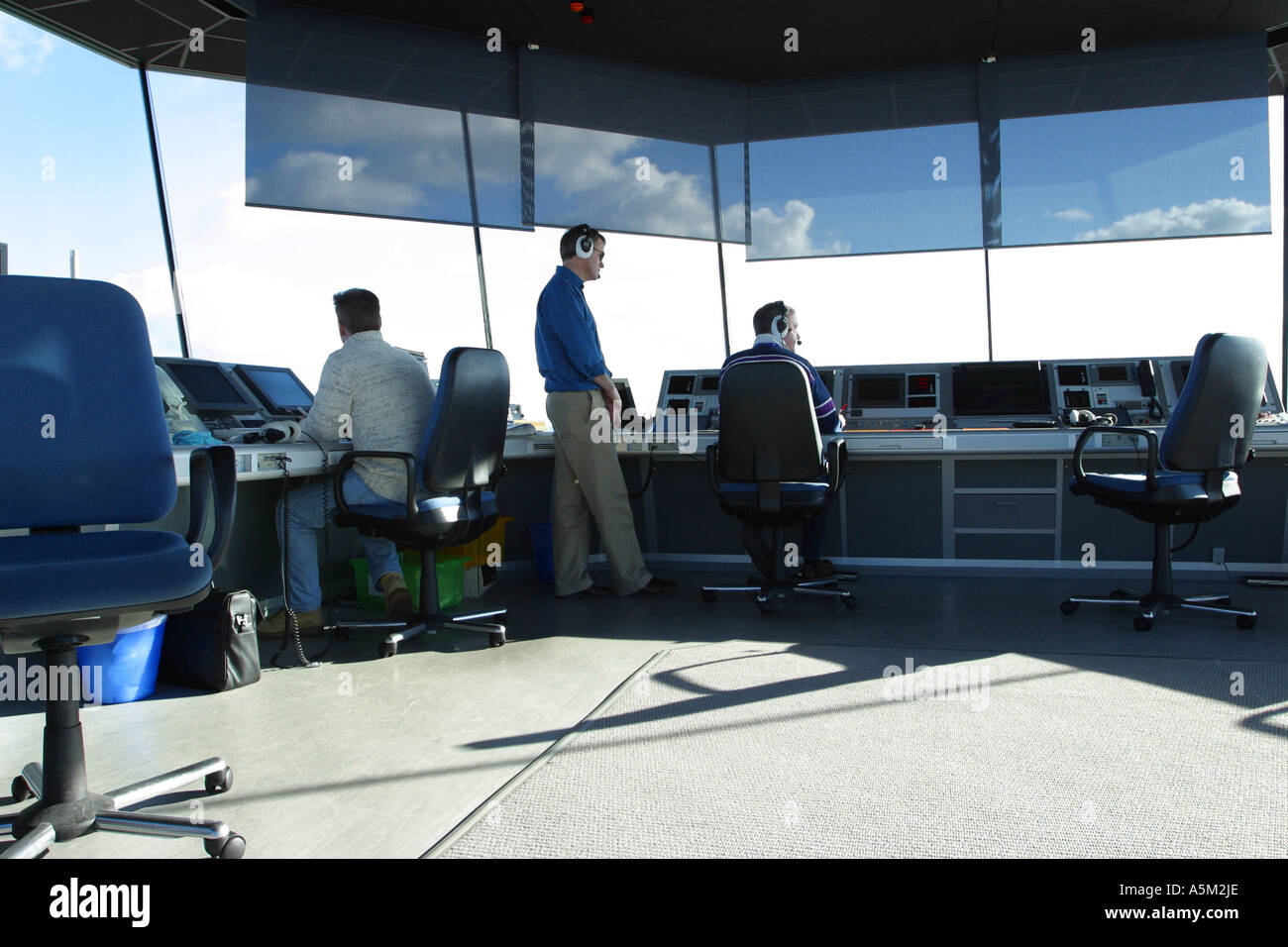 Air Traffic Controllers at work in an airport ATC control tower Stock Photo