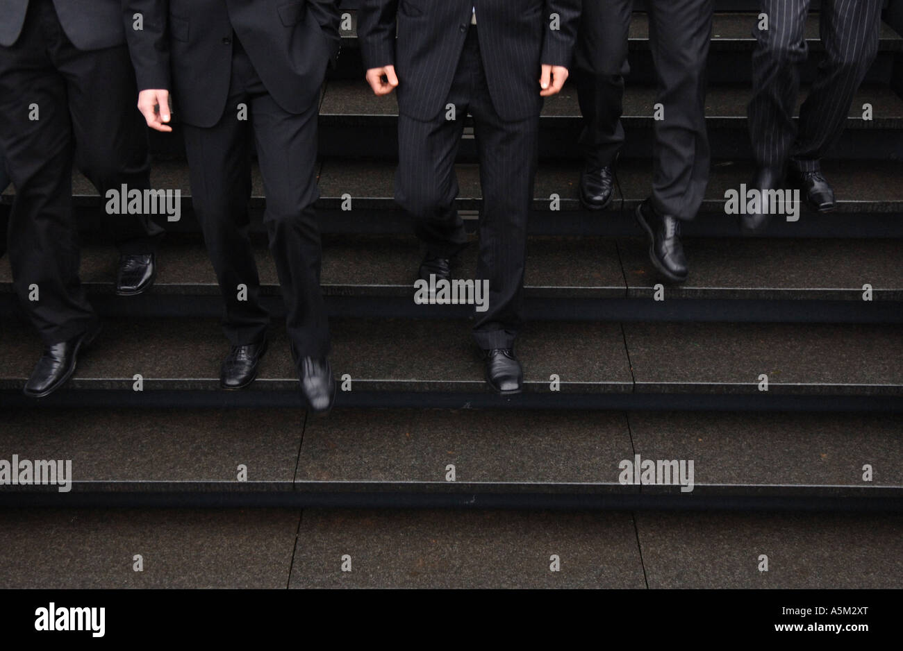 Businessmen walking down stairs hi-res stock photography and images - Alamy