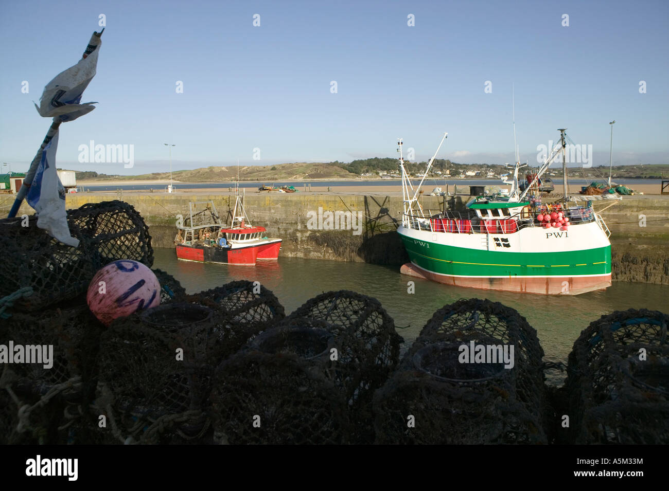 Crab pots and a fishing boat in the harbour at Padstow, Cornwall Stock Photo Alamy