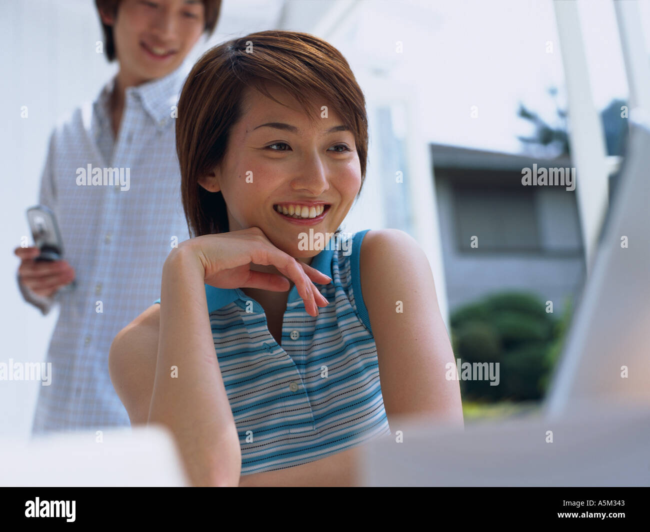 Asian Woman working on a laptop Stock Photo