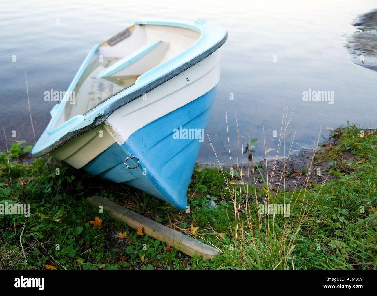 Stranded blue fiberglass rowing boat Stock Photo