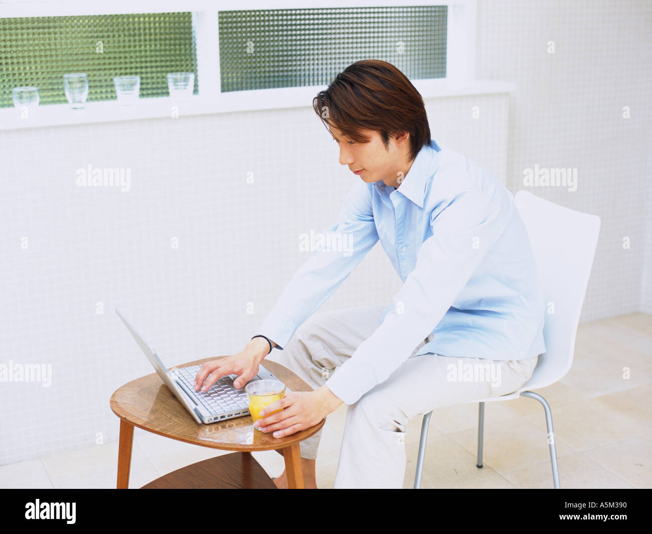 Asian man working on a laptop Stock Photo