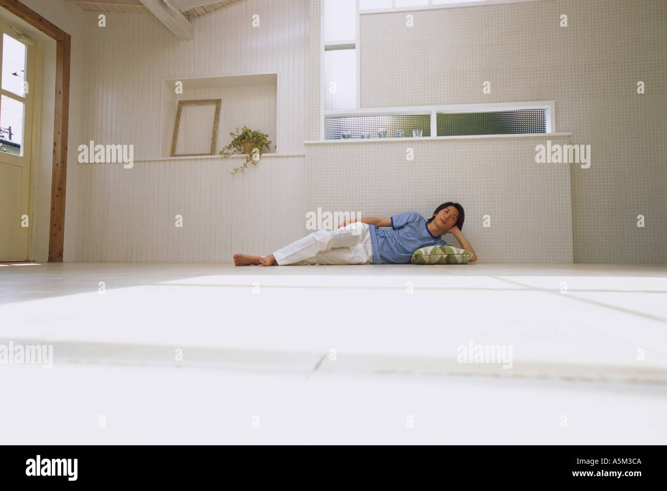 Asian Man lying on the floor Stock Photo