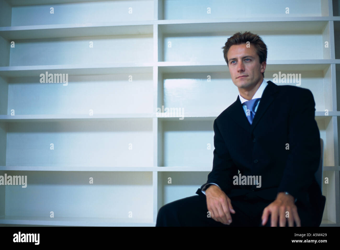 Caucasian man sitting in an empty office Stock Photo