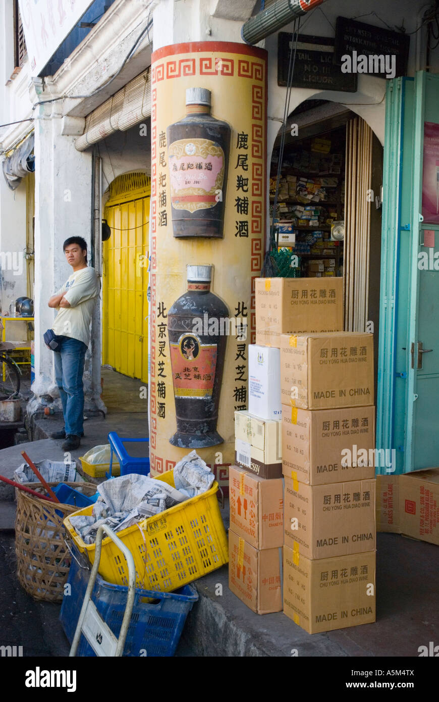 Boxes of products made in China stacked on the pavement outside a store