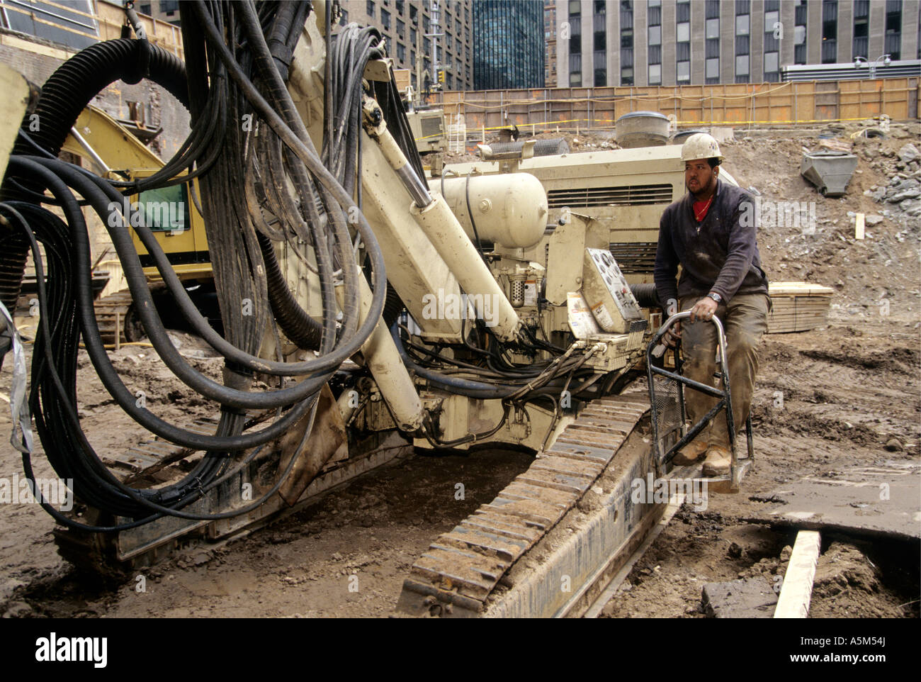 Drill operator with modified drill rig mounted on a backhoe platform