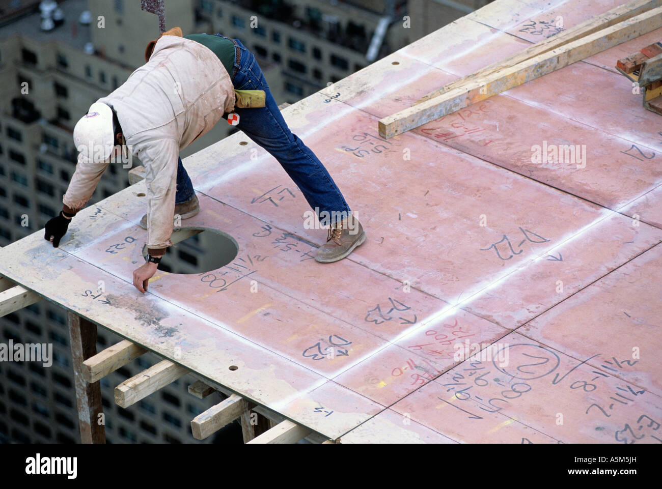 Carpenters build frame to pour reinforced concrete floors in New York ...