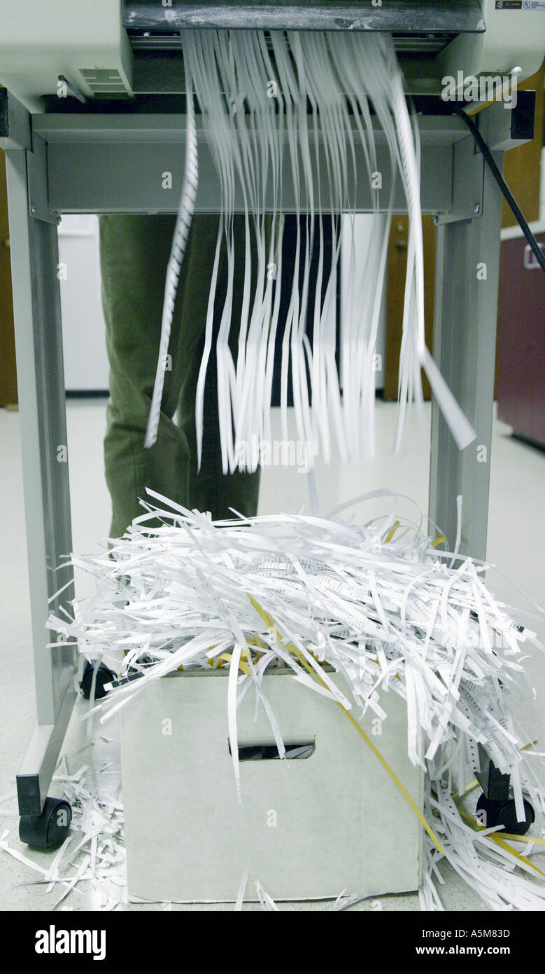 Paper shredder shredding papers in office building Stock Photo