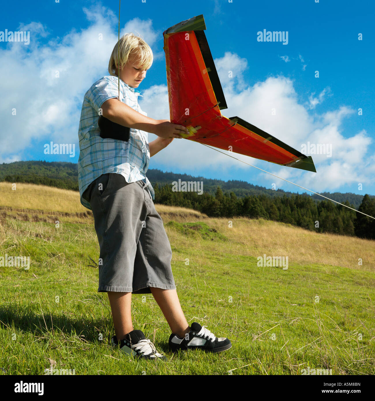 Pre teen Caucasian male preparing to fly remote controlled airplane on