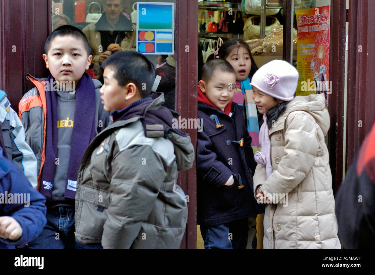 Paris France, Small Crowd Chinese French Children Celebrating 'Chinese New Year' on Street Festival Outside Family Store Portrait Stock Photo