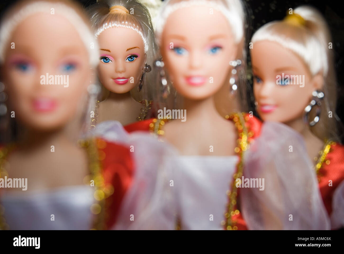 four identical dolls very narrow focus on back doll Stock Photo