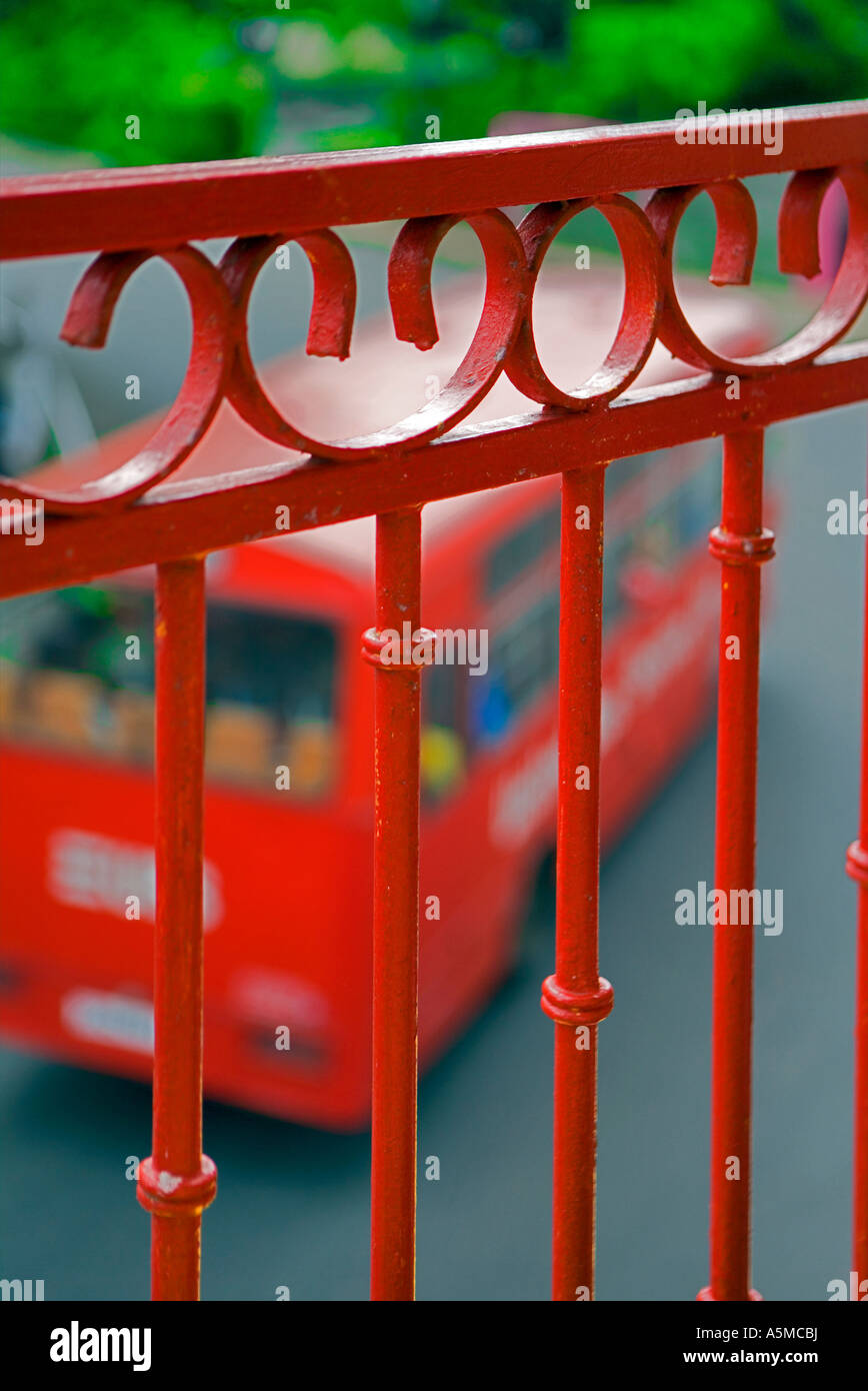Red railings with speeding red bus Stock Photo