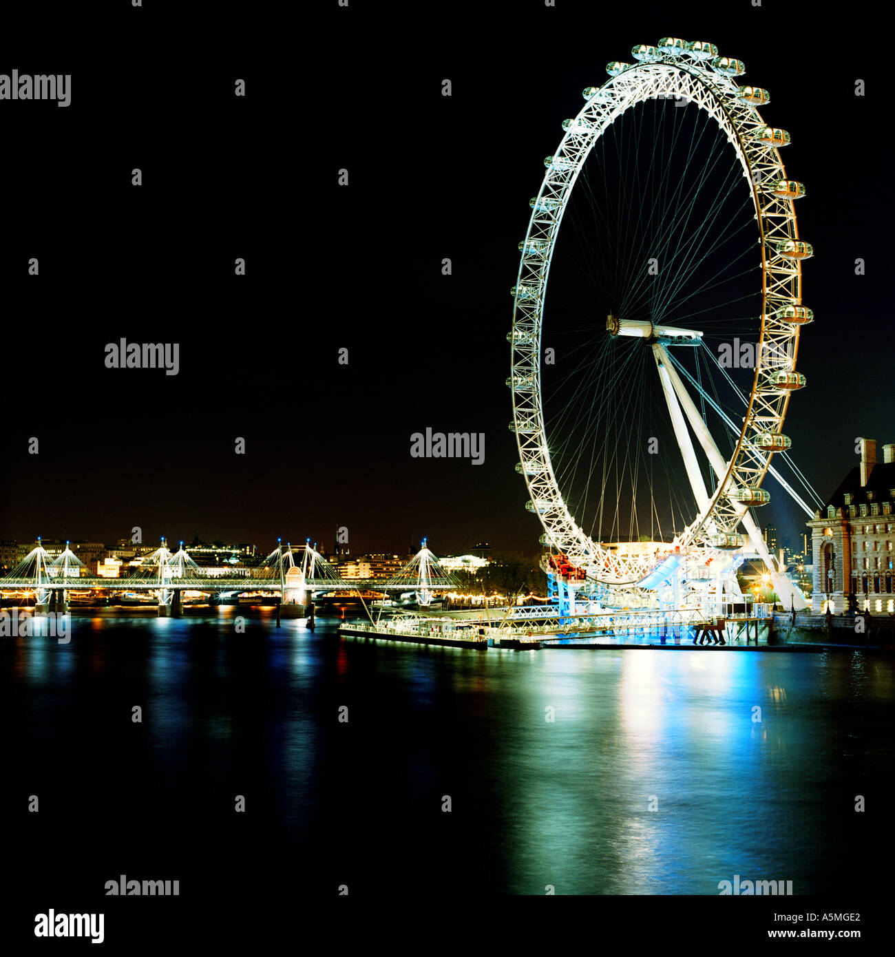 Night shot of BA London Eye Millennium Wheel Marks Barfield Architects inc. River Thames, Hungerford Bridge, County Hall, Southbank; London, England Stock Photo