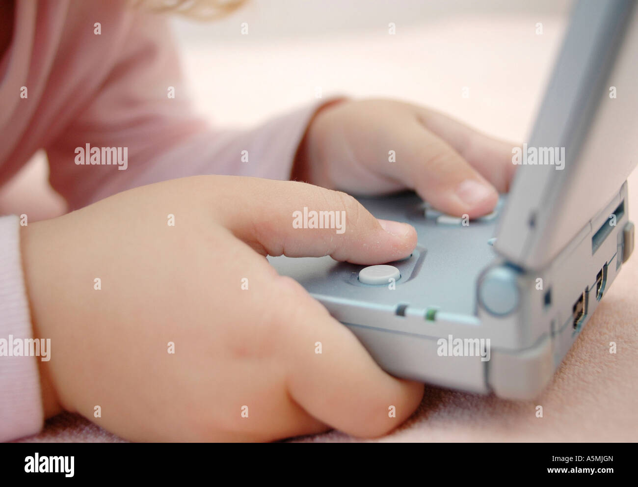 Kind spielt mit Gameboy child playing with Gameboy Kind Menschen Mensch Personen Leute people jung kindlich Kinder Kindheit chil Stock Photo