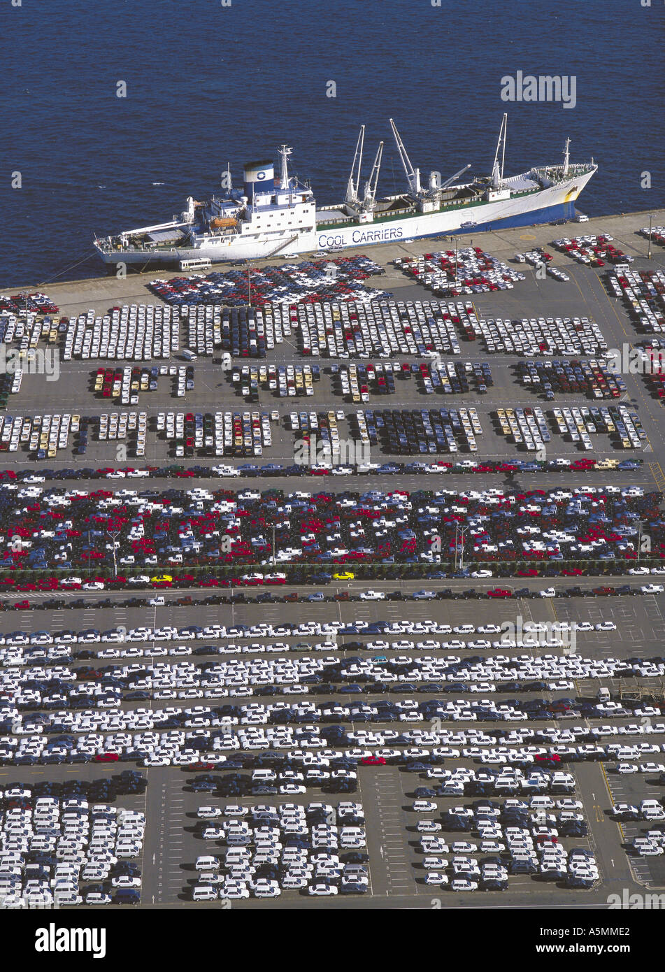 Aerial view of cars being loaded on ship for export from Yokohama Japan