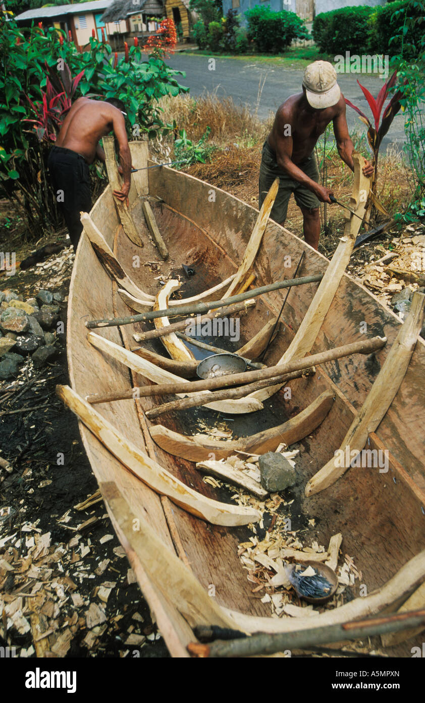 carib indians build boat by roadside in their village in
